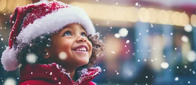 Happy Child Wearing Santa Hat During Winter Snowfall