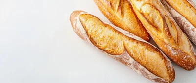 Freshly Baked French Baguettes On A White Surface