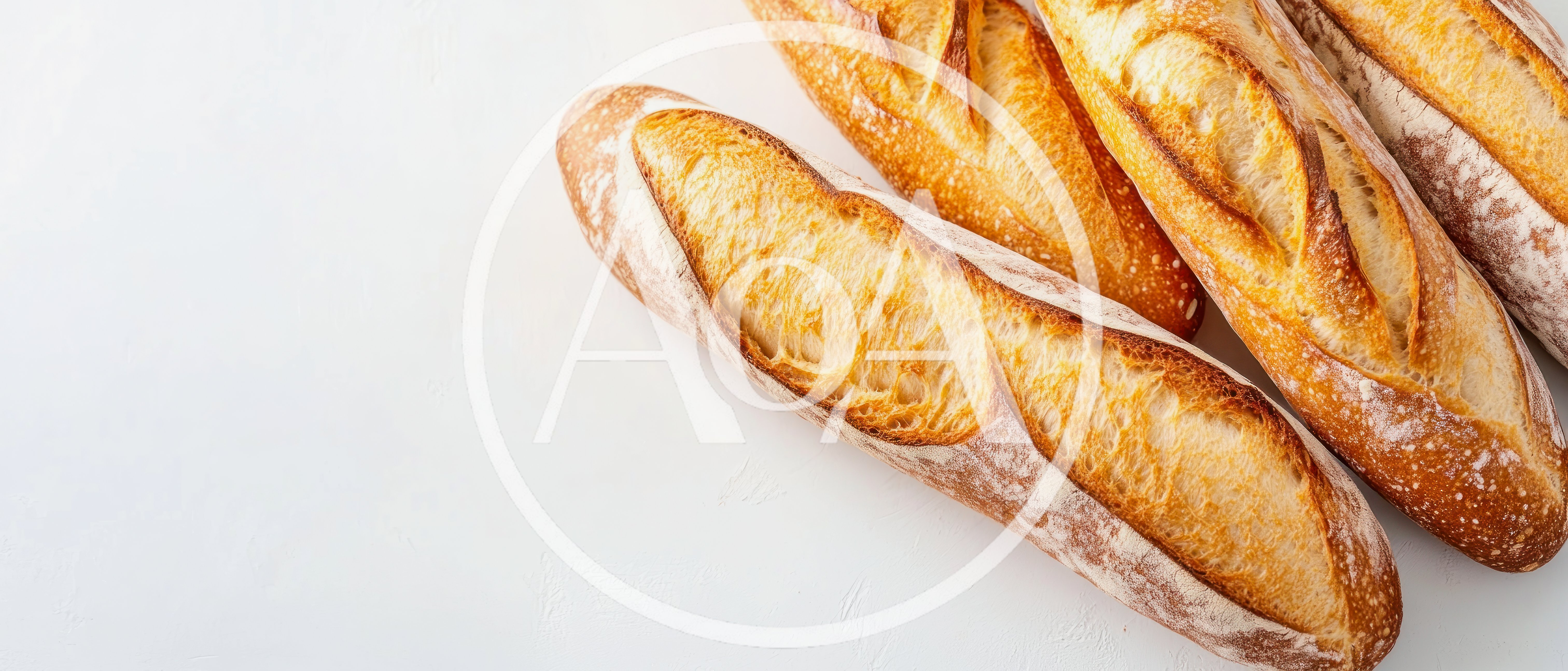 Freshly Baked French Baguettes On A White Surface