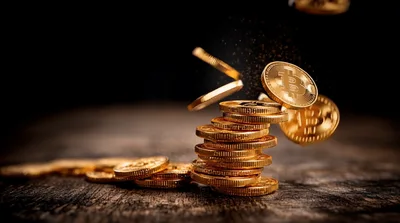 Golden Bitcoin Coins Falling Onto A Stack