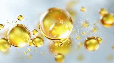 Golden Oil Droplets Floating In Liquid Suspension
