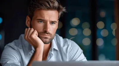 Stressed Businessman Working Late On Laptop In Office