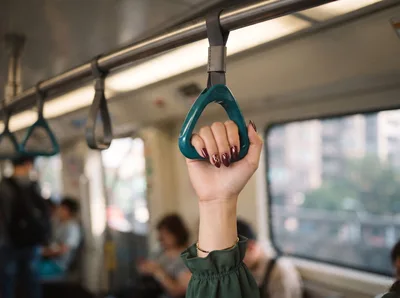 Woman Holding Onto Subway Train Handle