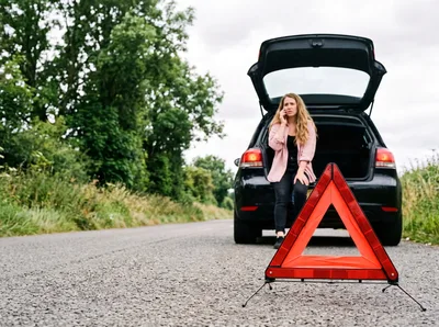 Woman Calling for Assistance Beside Broken Down Car