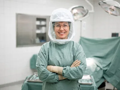 Female Surgeon Wearing Protective Helmet In Operating Room