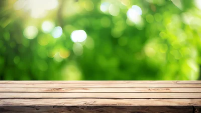 Empty Wooden Table Against Blurred Green Nature Background