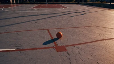 Basketball Resting On An Outdoor Court At Sunset