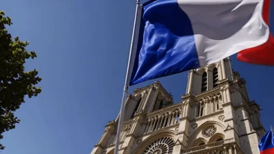 French Flags Waving Before Notre Dame Cathedral