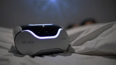 Futuristic AR Mask Device Resting On A Bed