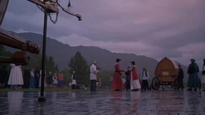 Pioneer Reenactors Dancing In The Rain At Sunset