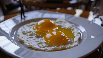 Miniature Figurine Standing Beside Fried Eggs On Plate