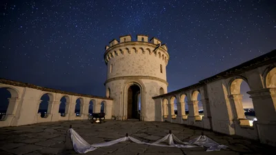 Starry Night Sky Over Ancient Stone Castle Tower