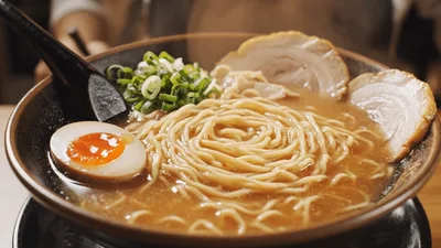 Chef Eating Steaming Bowl Of Ramen Noodles