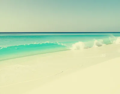Turquoise Ocean Wave Breaking On Tropical White Sand Beach