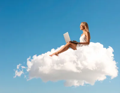 Woman Sitting On A Cloud Using A Laptop