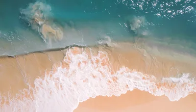 Aerial View Of Turquoise Ocean Waves Crashing On Beach