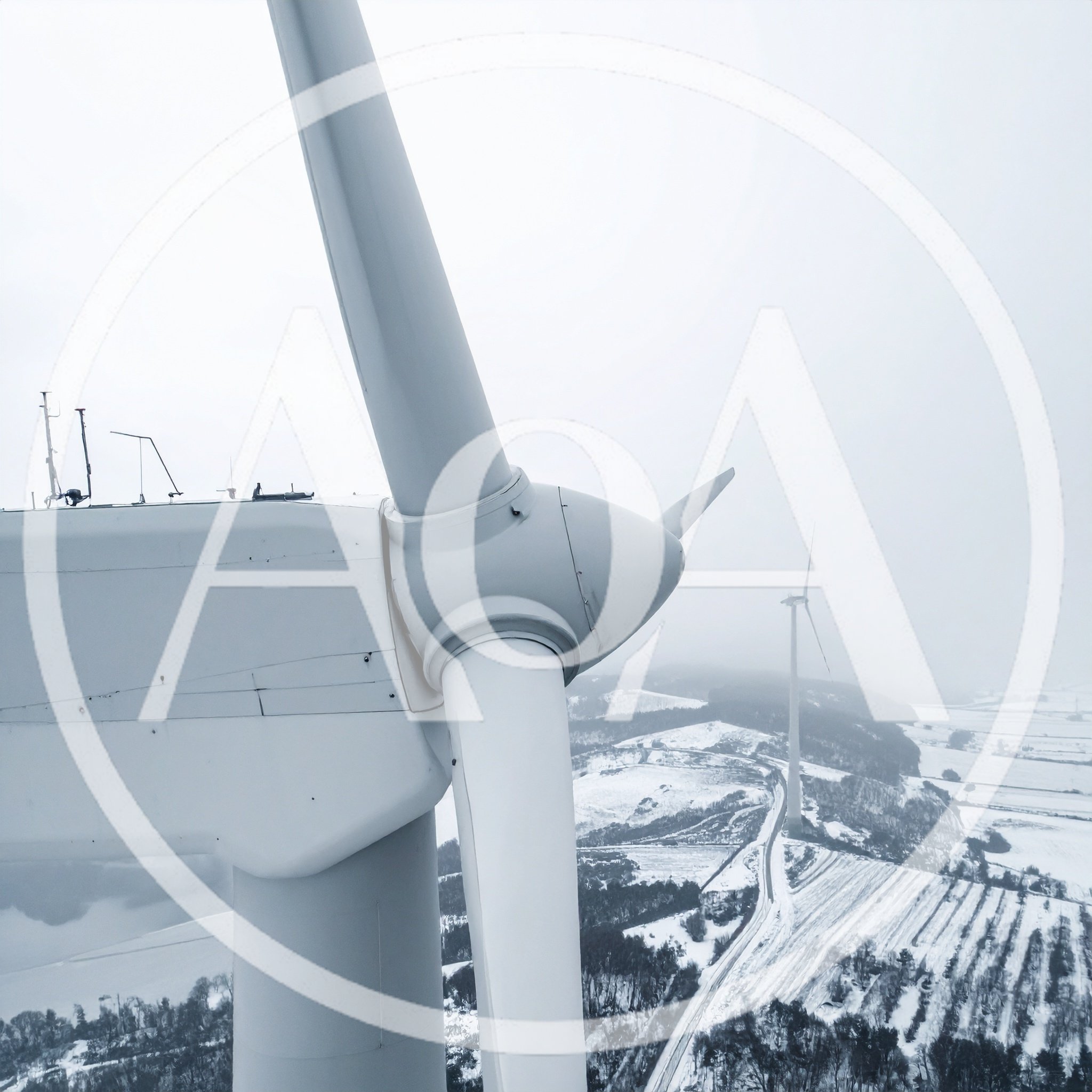 Aerial View Of Wind Turbines In Snowy Landscape