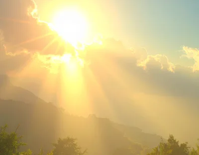 Golden Sun Rays Over Misty Mountain Landscape