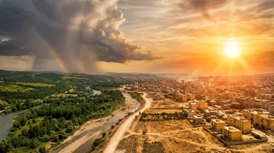Scorching hot city against green rainy landscape