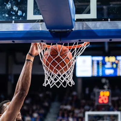 Basketball Player Performing A Powerful Slam Dunk