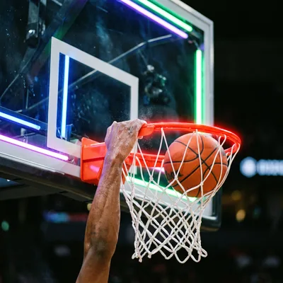 Basketball Player Performing A Powerful Slam Dunk