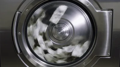 White Laundry Spinning Inside Industrial Washing Machine