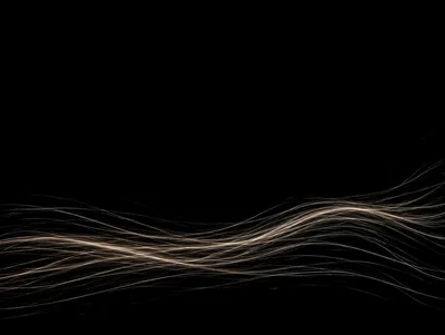 Abstract Light Trails Flowing On Black Background