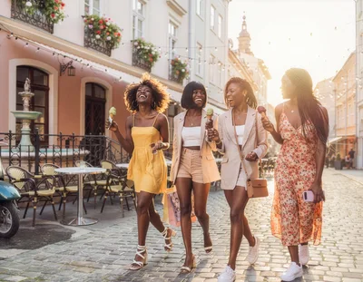 Four Happy Women Walking With Ice Cream Outdoors