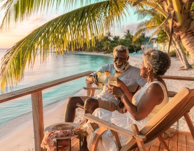 Senior Couple Enjoying Tropical Sunset Cocktails
