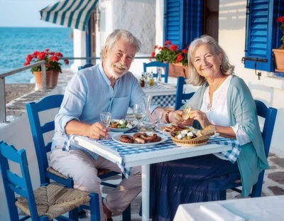 Senior Couple Enjoying Mediterranean Lunch By The Sea