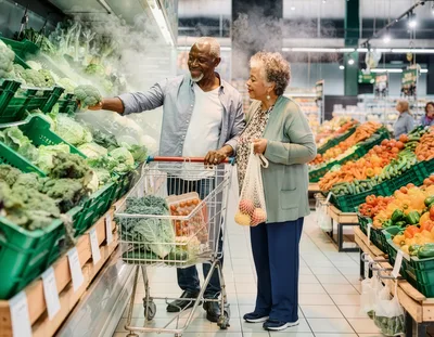 Senior Couple Shopping for Fresh Vegetables in Supermarket