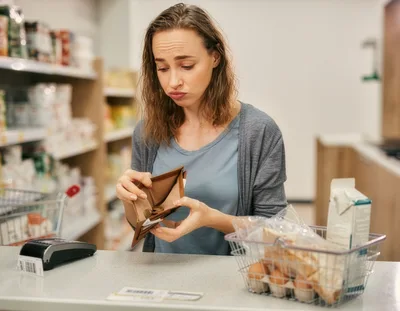 Woman Checking Empty Wallet at Grocery Store Checkout