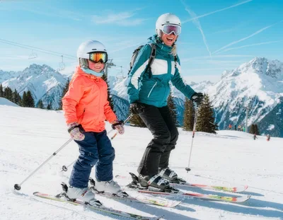 Mother and Daughter Skiing Together in the Alps