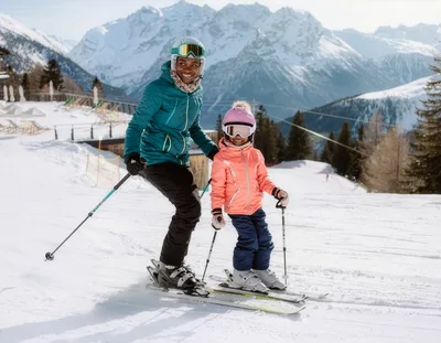 Mother and Daughter Skiing Together in the Alps