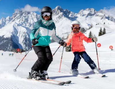 Mother and Daughter Skiing Together on Snowy Mountain