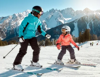Mother Teaching Young Daughter How To Ski