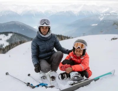 Mother And Son Skiing On Snowy Mountain Slope