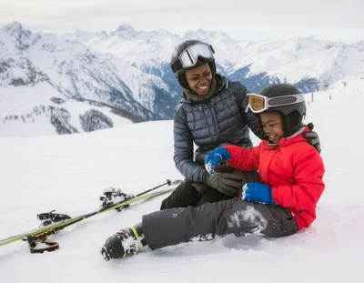 Mother And Son Skiing Together In The Mountains