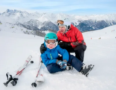 Grandmother Comforting Young Grandson After Skiing Fall