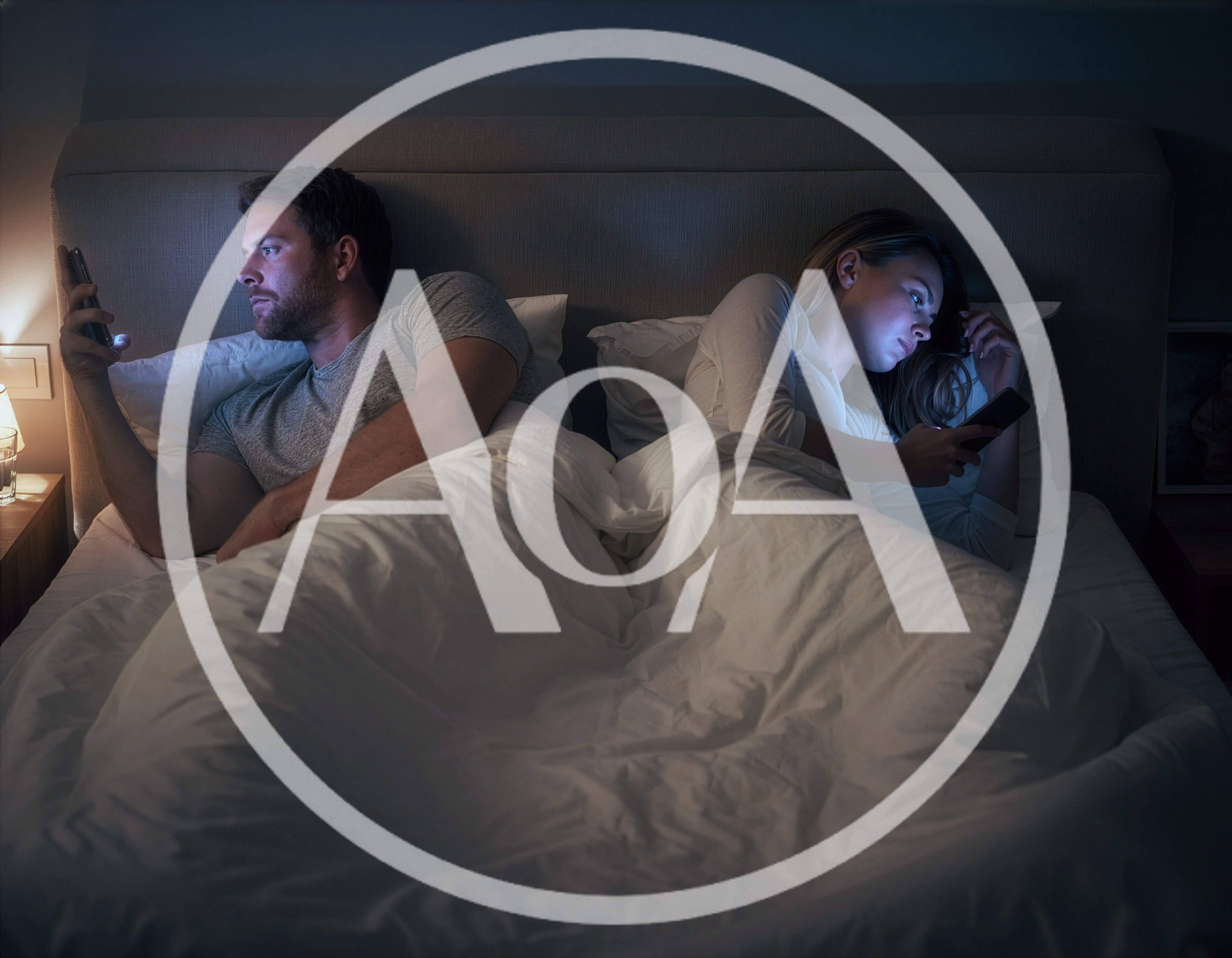 Couple Using Smartphones In Bed At Night