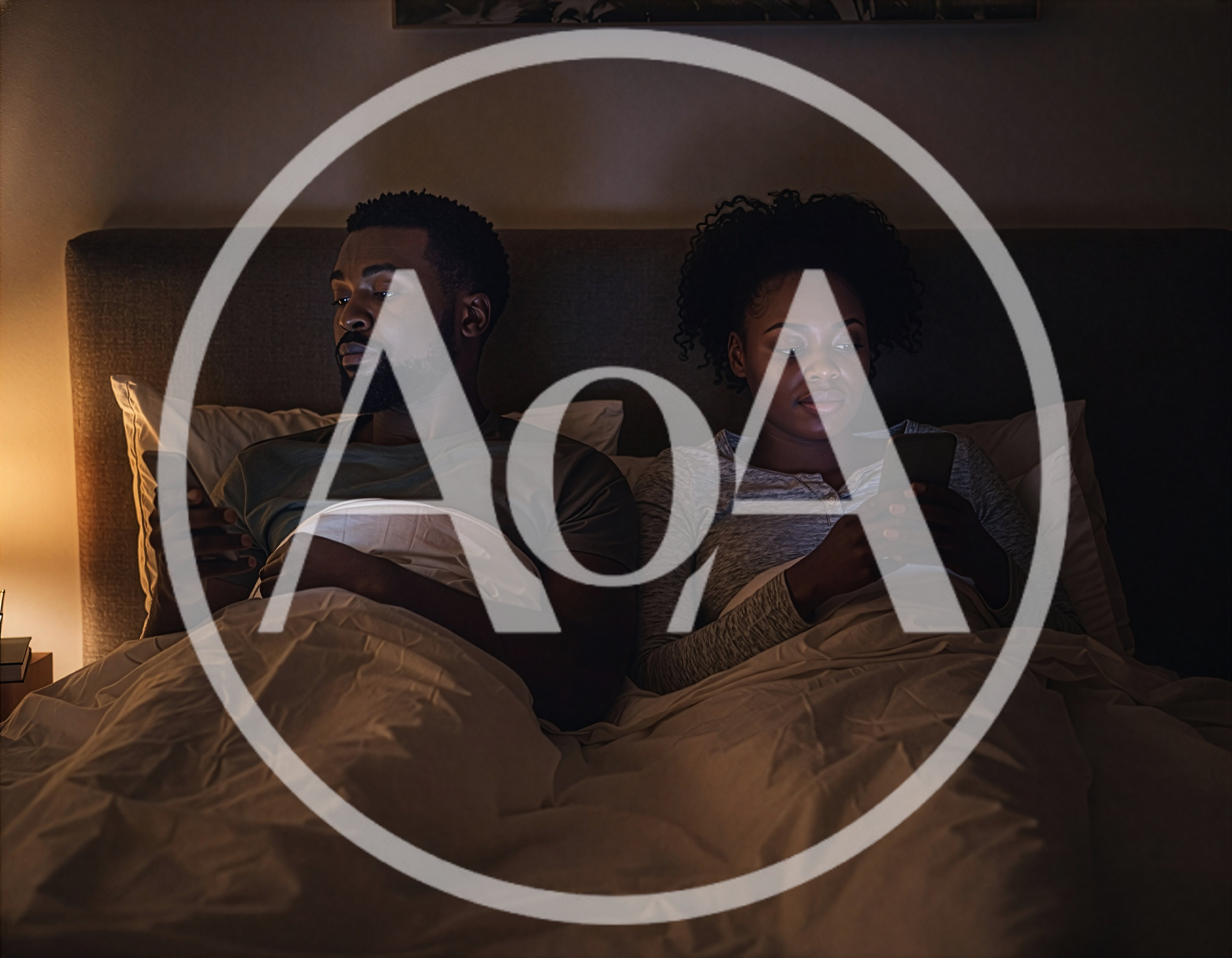 Couple Using Smartphones In Bed At Night