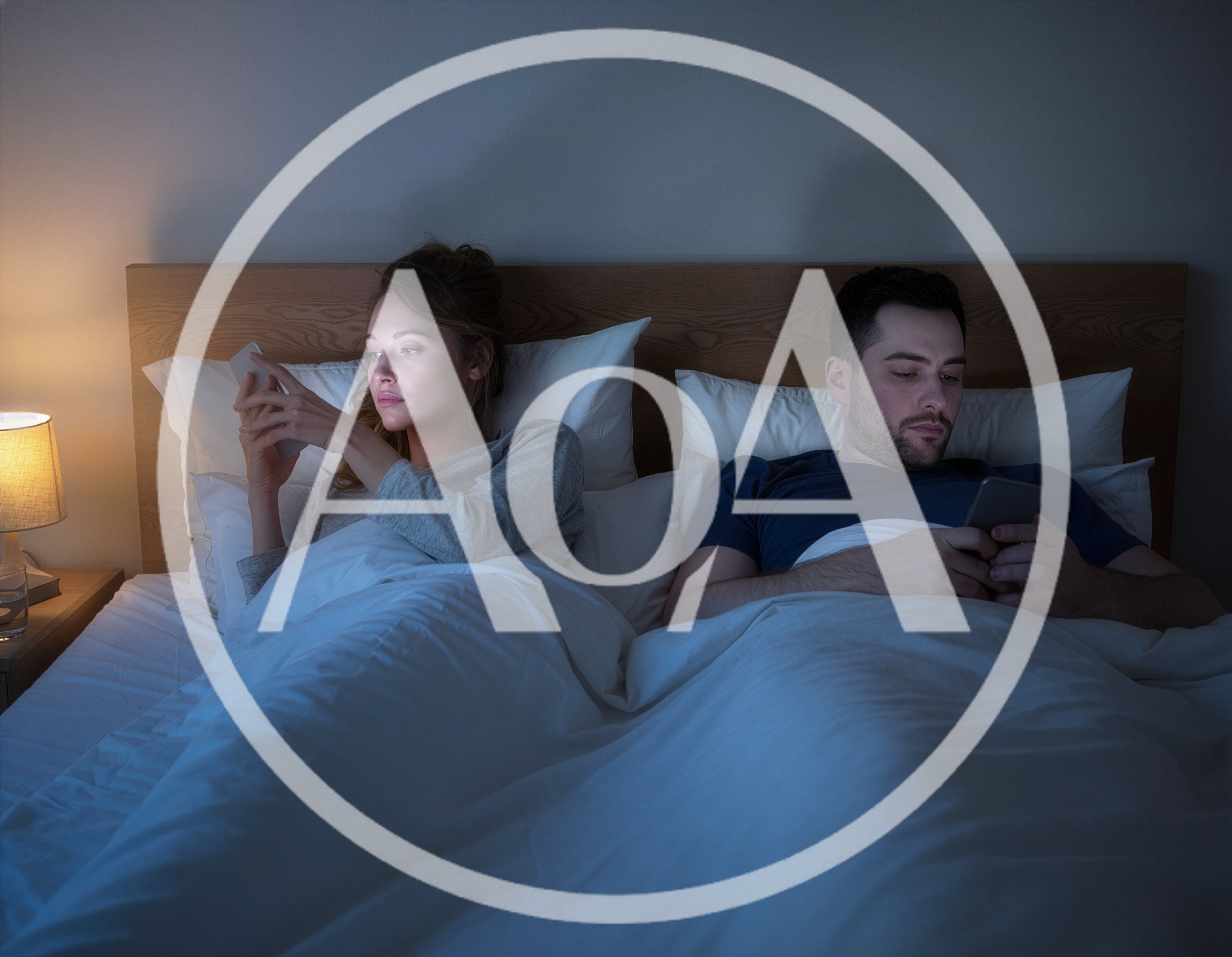Couple Using Smartphones In Bed At Night