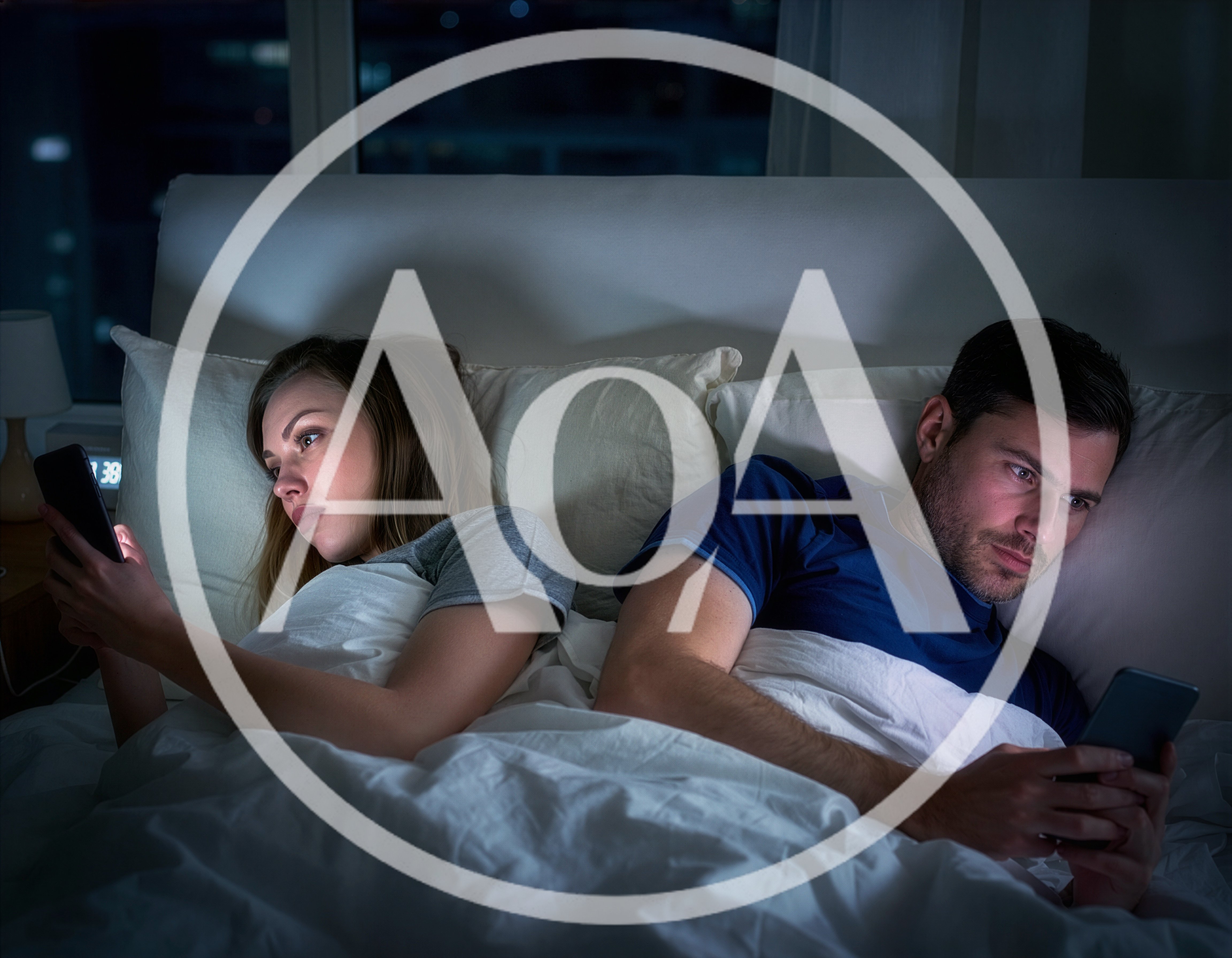 Couple Using Smartphones In Bed At Night