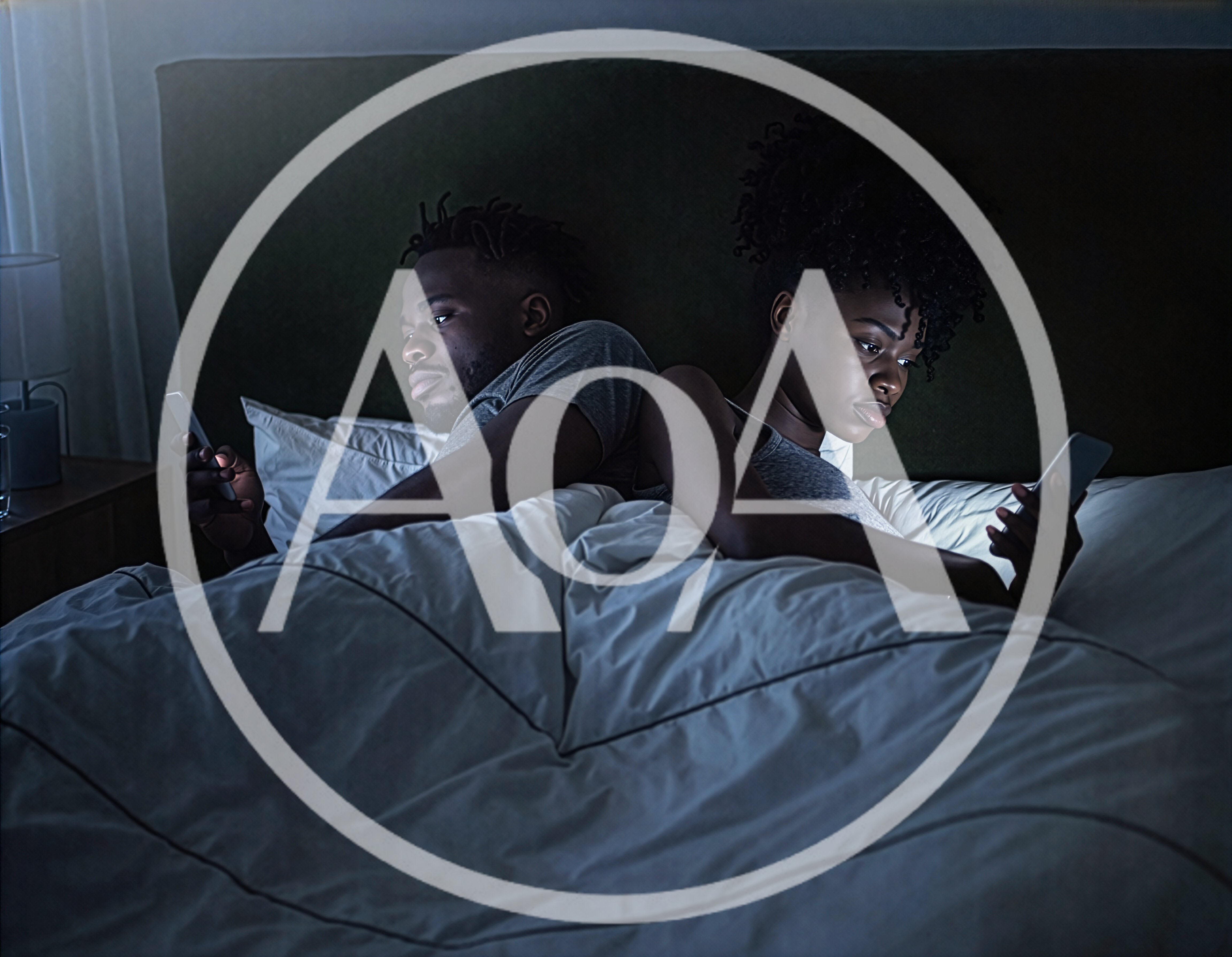 Young Couple Using Smartphones In Bed At Night