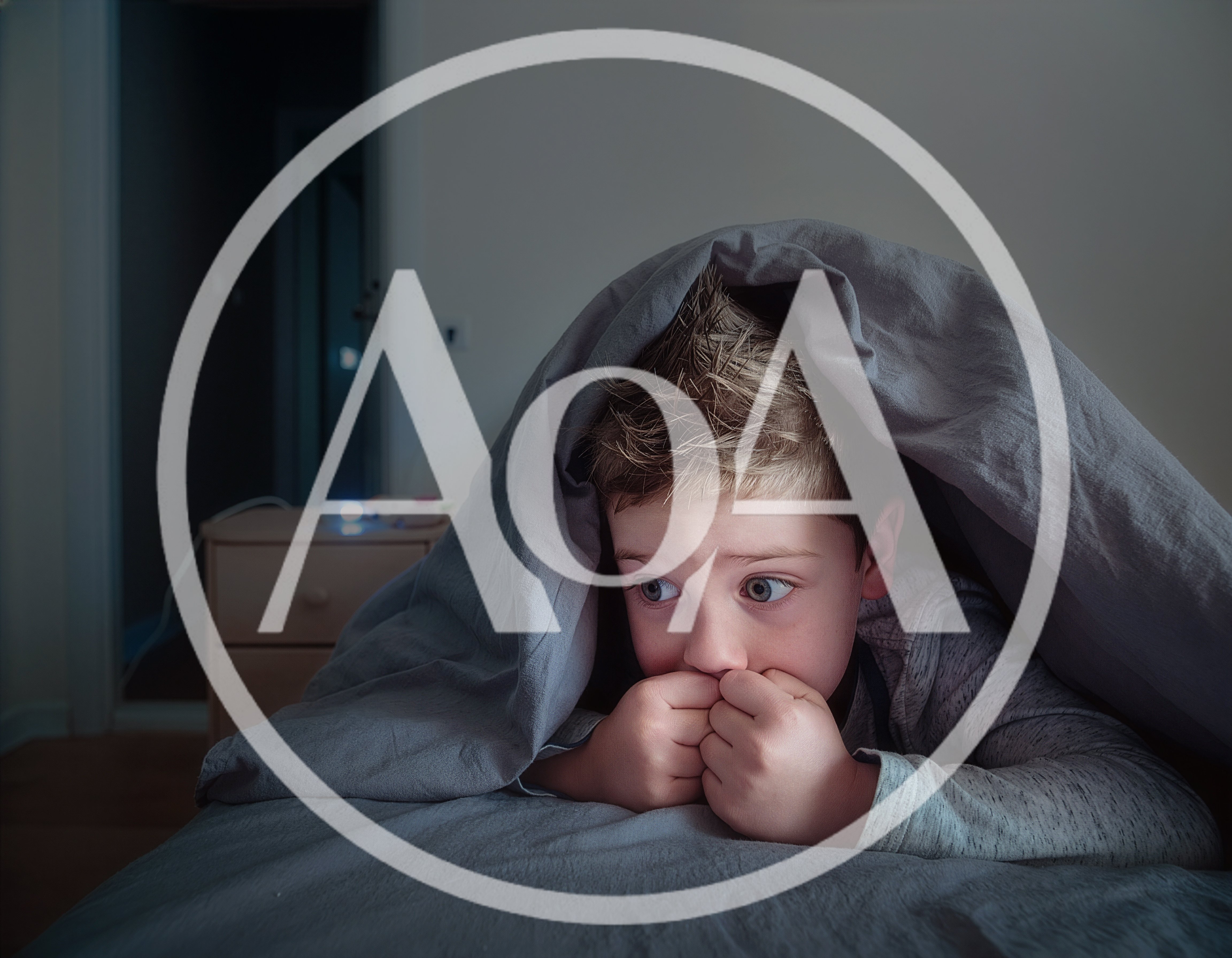 A child is lying in bed at home in dim lighting, peeking out from under the blanket, looking frightened. Night terror concept.