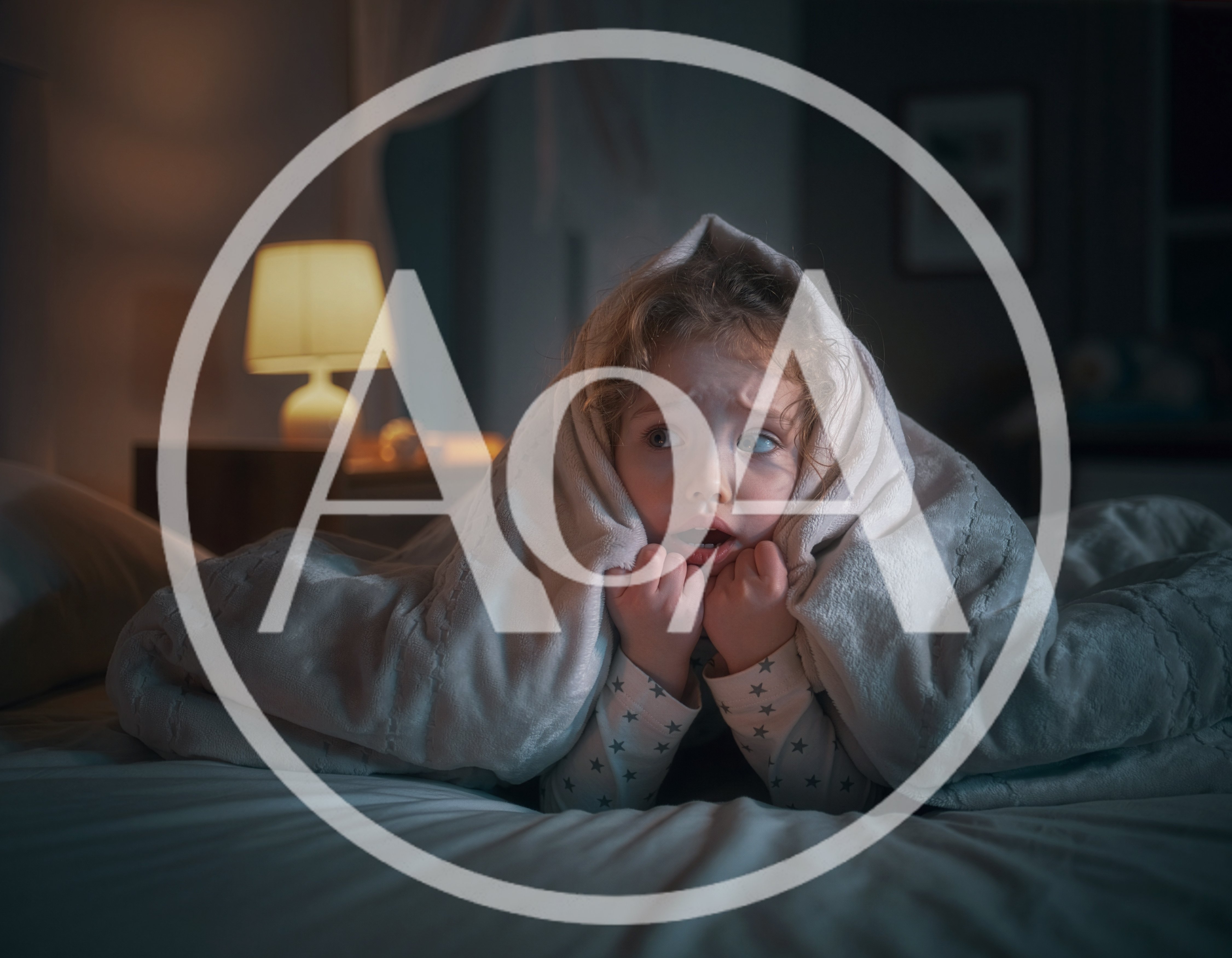 A child is lying in bed at home in dim lighting, peeking out from under the blanket, looking frightened. Night terror concept.