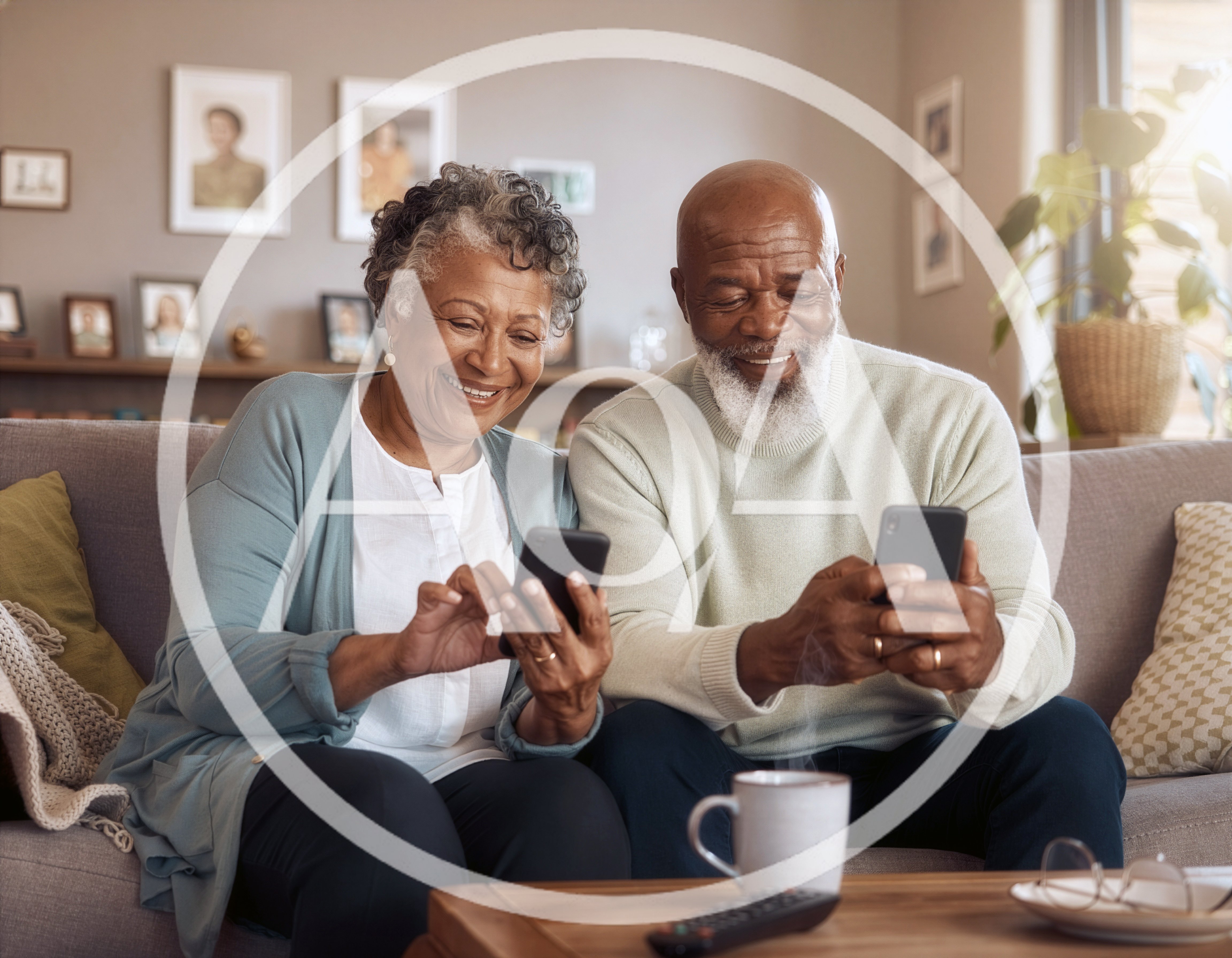 Senior Couple Using Smartphones Together On Sofa