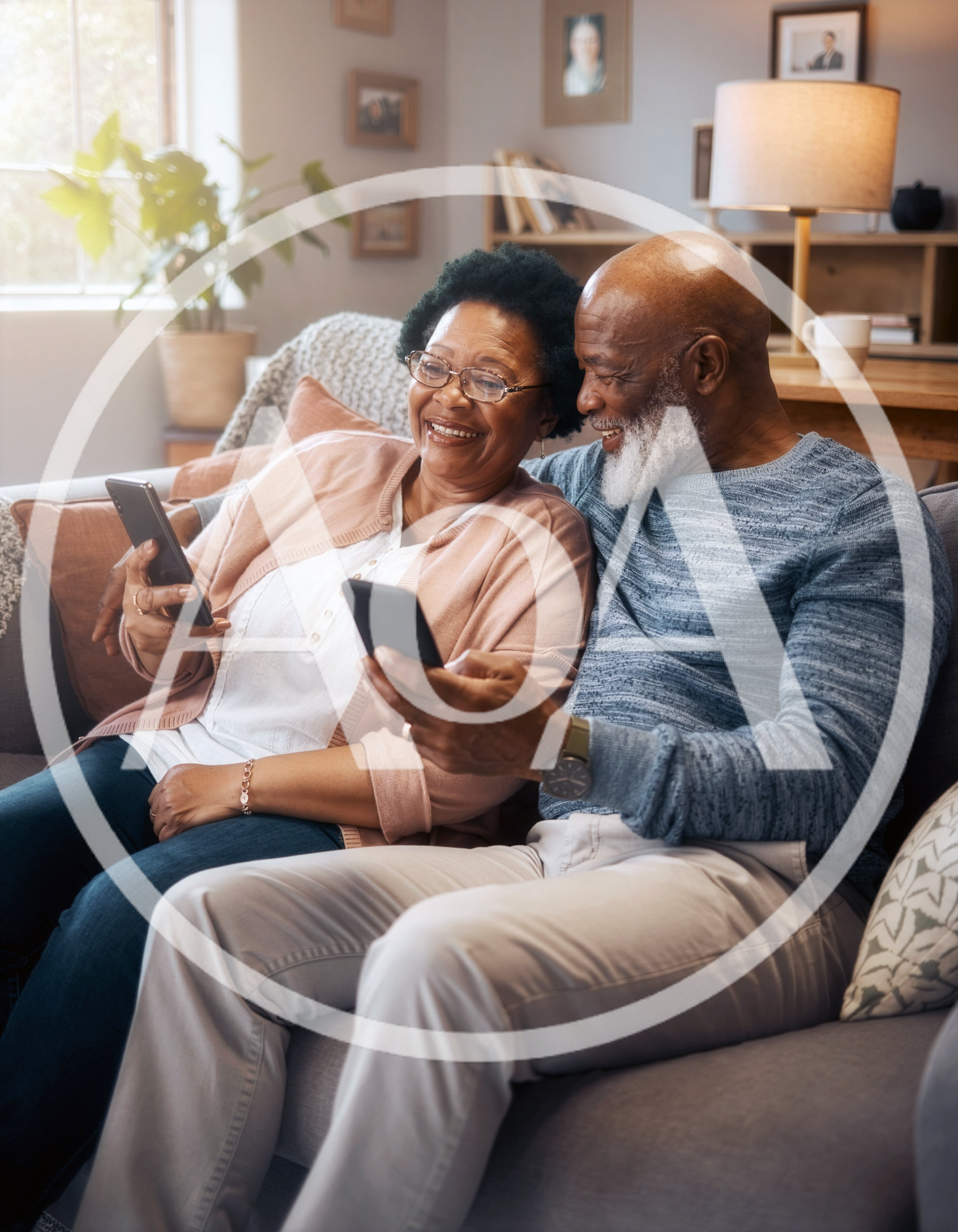 Senior Couple Using Smartphones Together on Sofa