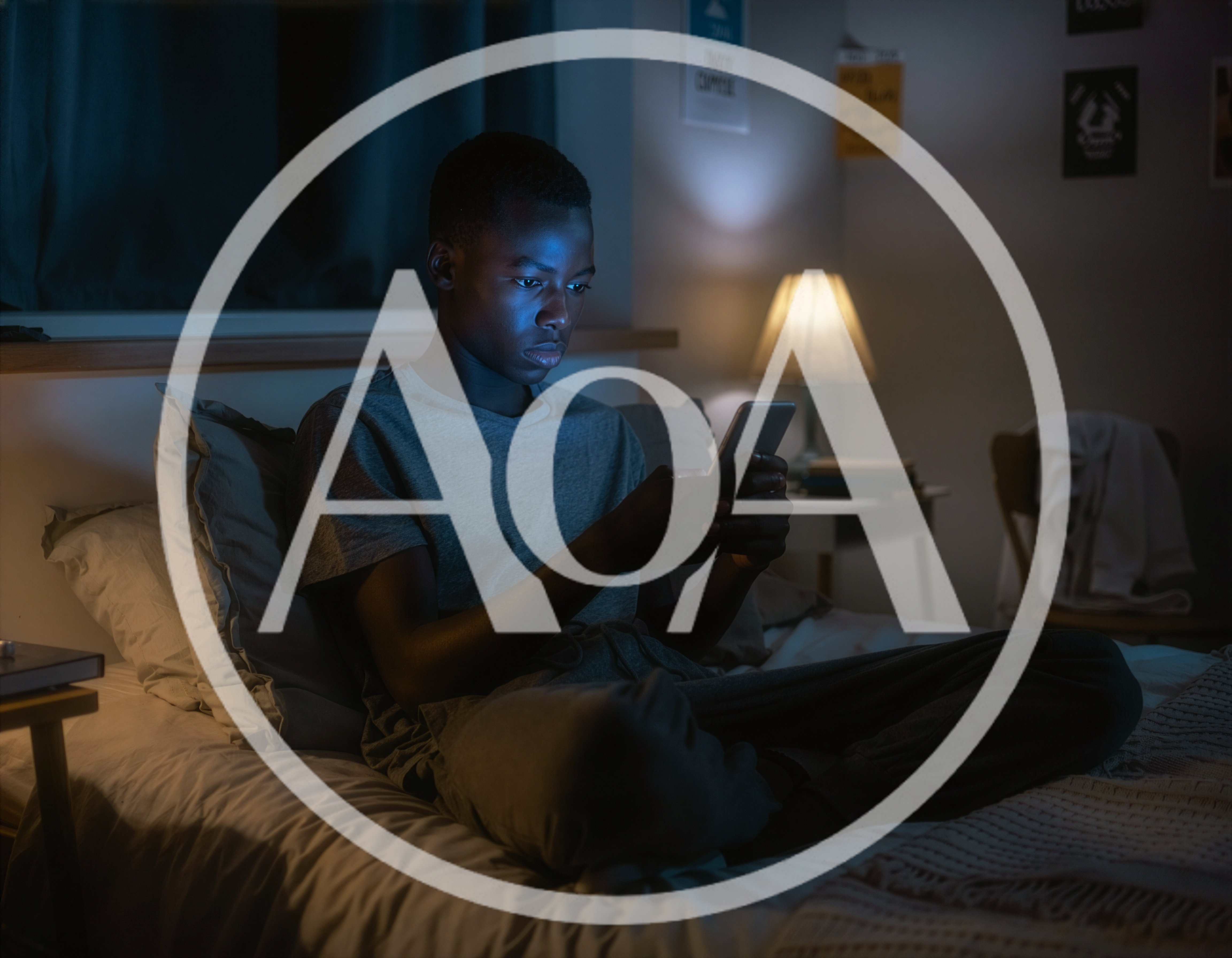 Young Man Using Smartphone In Bed At Night