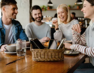 Friends Laughing Together at a Cafe Table